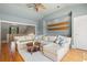 Open-concept living room with hardwood floors, a sectional sofa, and a ceiling fan at 66 New Settlement Rd, Kiawah Island, SC 29455