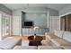 Comfortable living room with built-in cabinets, neutral color palette, and hardwood flooring at 66 New Settlement Rd, Kiawah Island, SC 29455