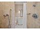 Shower with travertine tile and linen wallpaper at 66 New Settlement Rd, Kiawah Island, SC 29455