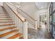 Staircase featuring wood steps, white risers and view into a living space, showcasing elegant design at 66 New Settlement Rd, Kiawah Island, SC 29455