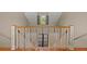 Staircase with wood steps, white risers, and trim, leading to an upper level window at 66 New Settlement Rd, Kiawah Island, SC 29455