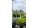 Outdoor patio area with seating surrounded by tropical plants and flowers at 711 Farm Cottage Ln, Charleston, SC 29412