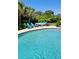 Inviting backyard pool area with comfortable blue chairs and an outdoor seating set, perfect for relaxing and entertaining at 711 Farm Cottage Ln, Charleston, SC 29412