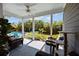 Inviting covered patio featuring comfortable seating, a ceiling fan, and a view of the lush backyard and refreshing pool at 711 Farm Cottage Ln, Charleston, SC 29412