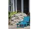 Relaxing front porch featuring a blue lounge chair and flower garden at 711 Farm Cottage Ln, Charleston, SC 29412