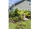 Beautiful backyard landscaping featuring banana trees, flower beds and privacy fence at 711 Farm Cottage Ln, Charleston, SC 29412