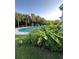Relaxing poolside scene with lush landscaping, comfortable seating, and a refreshing pool for ultimate outdoor enjoyment at 711 Farm Cottage Ln, Charleston, SC 29412