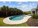 Beautiful backyard pool surrounded by lush tropical landscaping and comfortable seating at 711 Farm Cottage Ln, Charleston, SC 29412