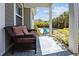 Relaxing covered porch with wicker furniture overlooking the sparkling backyard pool at 711 Farm Cottage Ln, Charleston, SC 29412