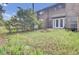 Spacious backyard with patio, lawn, brick fire pit, and exterior view of the home at 8644 Roanoke Dr, North Charleston, SC 29406