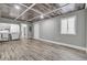Finished basement featuring a decorative paneled ceiling, wood-look laminate flooring, and laundry area at 8644 Roanoke Dr, North Charleston, SC 29406