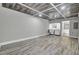 Finished basement with a decorative paneled ceiling and wood-look laminate flooring at 8644 Roanoke Dr, North Charleston, SC 29406