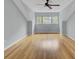 Large bedroom features hardwood floors, a ceiling fan, and a window with a view at 8644 Roanoke Dr, North Charleston, SC 29406