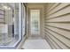 Close up of front door with sidelight and neutral exterior at 8644 Roanoke Dr, North Charleston, SC 29406
