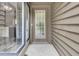 Close up of front door with sidelight and neutral exterior at 8644 Roanoke Dr, North Charleston, SC 29406