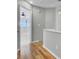 Upstairs hallway with gleaming hardwood floors leading to a bedroom with a ceiling fan at 8644 Roanoke Dr, North Charleston, SC 29406