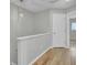Upstairs hallway features hardwood floors and a decorative light fixture at 8644 Roanoke Dr, North Charleston, SC 29406