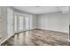 Spacious living room with laminate flooring and access to outdoor space through double doors at 8644 Roanoke Dr, North Charleston, SC 29406