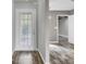 Open living space with wood floors leading to kitchen and basement at 8644 Roanoke Dr, North Charleston, SC 29406
