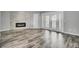 Spacious living room featuring wood floors and an electric fireplace at 8644 Roanoke Dr, North Charleston, SC 29406