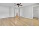 Expansive bedroom with hardwood floors, ceiling fan, and open doorway to bathroom at 8644 Roanoke Dr, North Charleston, SC 29406