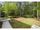 Spacious backyard with mature trees and a patio perfect for outdoor enjoyment at 8986 N Red Maple Cir, Summerville, SC 29485