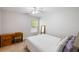 Guest bedroom featuring a wooden desk, a large window, and a comfortable bed at 8986 N Red Maple Cir, Summerville, SC 29485