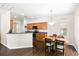 Eat-in kitchen featuring wood cabinets, modern appliances, and hardwood floors at 8986 N Red Maple Cir, Summerville, SC 29485