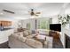 Bright living room with a fireplace, neutral decor, and a large window overlooking the backyard at 8986 N Red Maple Cir, Summerville, SC 29485