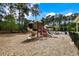 A modern playground with slides and climbing structures set in a safe, wooded area at 8986 N Red Maple Cir, Summerville, SC 29485