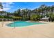 A pristine community pool surrounded by lush greenery and comfortable lounge chairs at 8986 N Red Maple Cir, Summerville, SC 29485