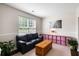 Cozy seating area with a comfortable couch, decorative accents, and natural light at 8986 N Red Maple Cir, Summerville, SC 29485