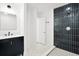 Chic bathroom featuring modern vanity, black tiled shower and updated fixtures at 920 Julia St, Charleston, SC 29412