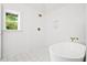 Bright bathroom featuring a soaking tub, shower and updated gold fixtures at 920 Julia St, Charleston, SC 29412