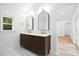 Modern bathroom featuring double vanity with stone countertop and elegant mirrors at 920 Julia St, Charleston, SC 29412