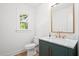 Updated powder room with stylish vanity, marble countertop, and decorative mirror at 920 Julia St, Charleston, SC 29412