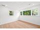 Bright bedroom with light wood floors and windows offering lush, outdoor views at 920 Julia St, Charleston, SC 29412