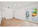 Spacious bedroom with light wood floors, white walls, and double doors opening to backyard at 920 Julia St, Charleston, SC 29412