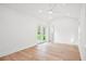 Bright bedroom boasts wood floors, white walls, ceiling fan and double doors to the backyard at 920 Julia St, Charleston, SC 29412