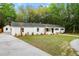 Charming white brick home with a well-maintained lawn and mature trees, offering a peaceful and inviting curb appeal at 920 Julia St, Charleston, SC 29412