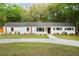 Lovely home showcasing its white exterior, neatly landscaped front yard and mature trees at 920 Julia St, Charleston, SC 29412
