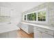 Bright kitchen featuring marble backsplash, custom cabinetry, and a large window overlooking backyard at 920 Julia St, Charleston, SC 29412