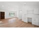 Spacious living area with white walls, light wood floors, built-in desk, and plenty of natural light at 920 Julia St, Charleston, SC 29412