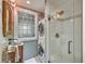 Compact bathroom featuring a unique vessel sink, laundry unit, and glass shower at 95 Ashley Ave # D, Charleston, SC 29401