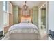 Charming bedroom with a chandelier and ensuite bathroom access at 95 Ashley Ave # D, Charleston, SC 29401