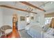 Cozy bedroom with exposed beams, hardwood floors, and an ensuite bathroom at 95 Ashley Ave # D, Charleston, SC 29401