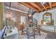 Elegant dining area with exposed brick, a spiral staircase, and a chandelier at 95 Ashley Ave # D, Charleston, SC 29401