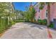 Spacious driveway with lush landscaping and mature trees, offering ample parking and curb appeal at 95 Ashley Ave # D, Charleston, SC 29401