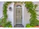 Elegant front door framed by climbing vines and stylish lanterns, creating a welcoming entrance at 95 Ashley Ave # D, Charleston, SC 29401