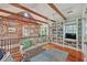 Cozy living room featuring exposed beams, brick accents, and built-in bookshelves at 95 Ashley Ave # D, Charleston, SC 29401